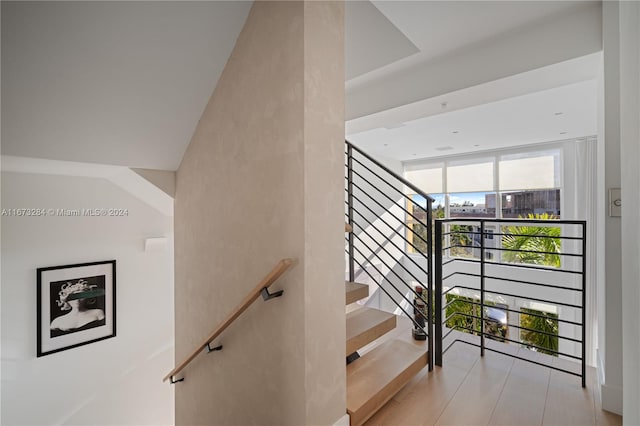 staircase with hardwood / wood-style floors