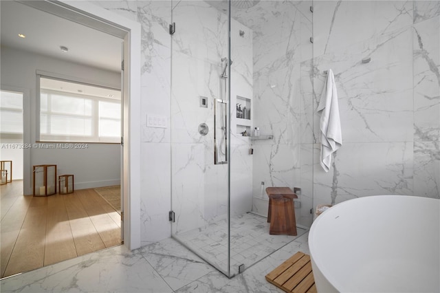 bathroom featuring shower with separate bathtub