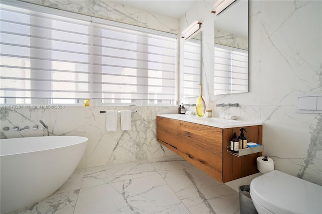 bathroom featuring vanity, tile walls, a bathtub, and toilet