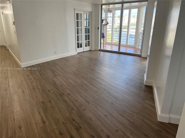 spare room with dark hardwood / wood-style floors and french doors