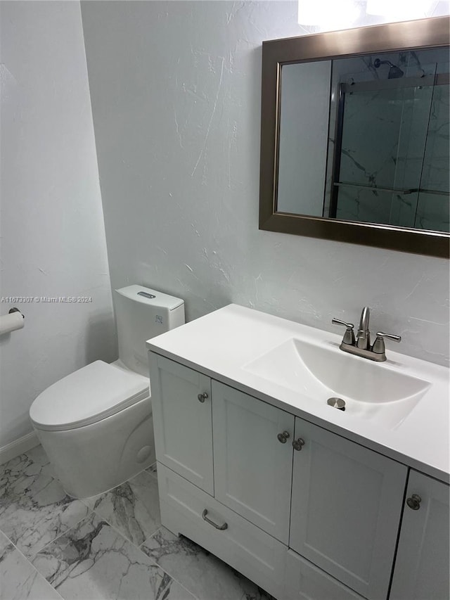 bathroom with a shower, vanity, and toilet