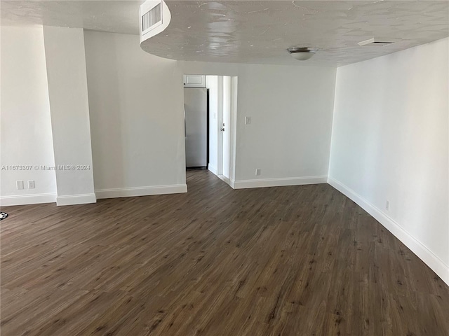 spare room with dark hardwood / wood-style flooring