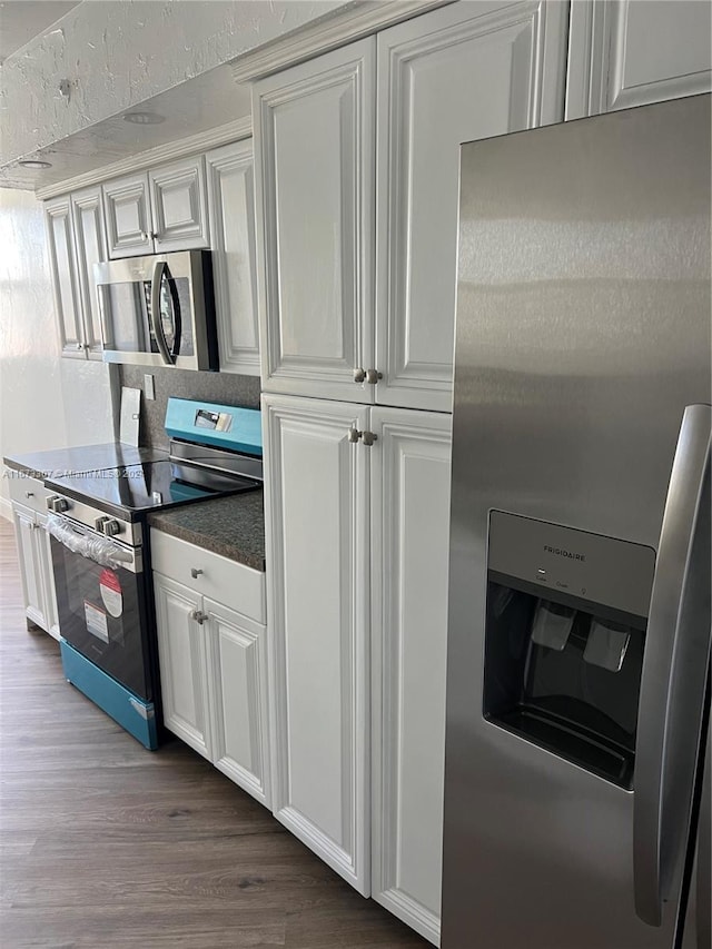 kitchen with white cabinetry, hardwood / wood-style floors, and stainless steel appliances