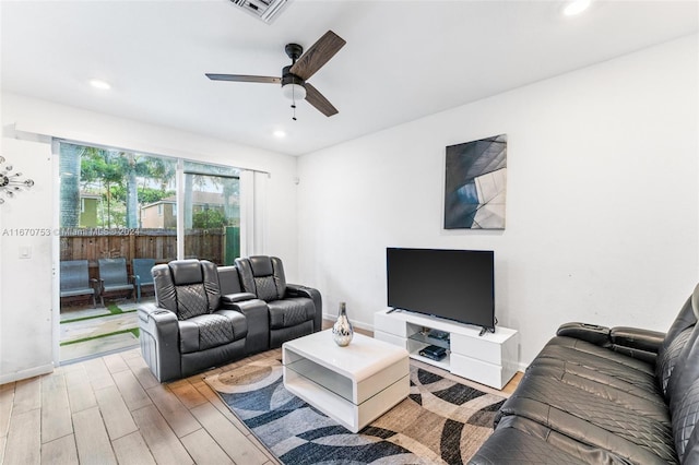 living room with ceiling fan and light hardwood / wood-style floors