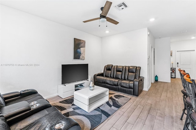 living room with light wood-type flooring and ceiling fan