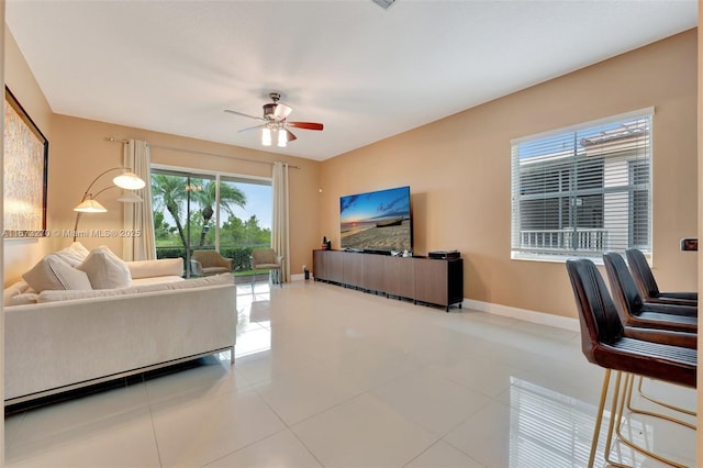 living room featuring tile patterned floors and ceiling fan