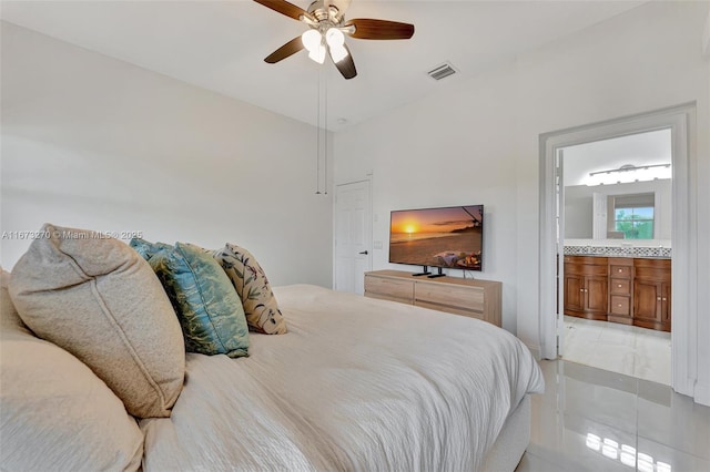 tiled bedroom featuring ceiling fan and connected bathroom