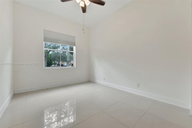 spare room featuring light tile patterned flooring and ceiling fan