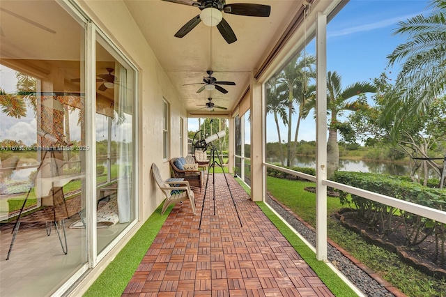 sunroom featuring a water view