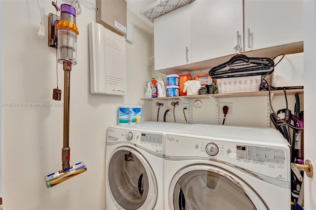 laundry area featuring cabinets and separate washer and dryer