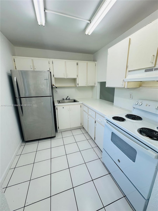 505 NW 177th St Unit 139, Miami Gardens, FL 33169 - kitchen with white range with electric cooktop, freestanding refrigerator, under cabinet range hood, a sink, and white cabinets