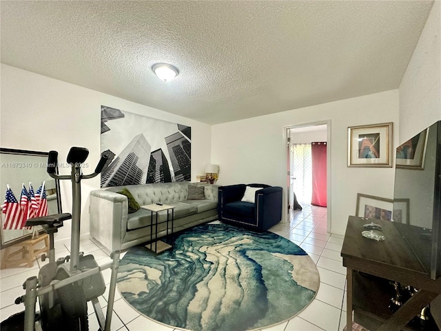 living area featuring light tile patterned flooring and a textured ceiling