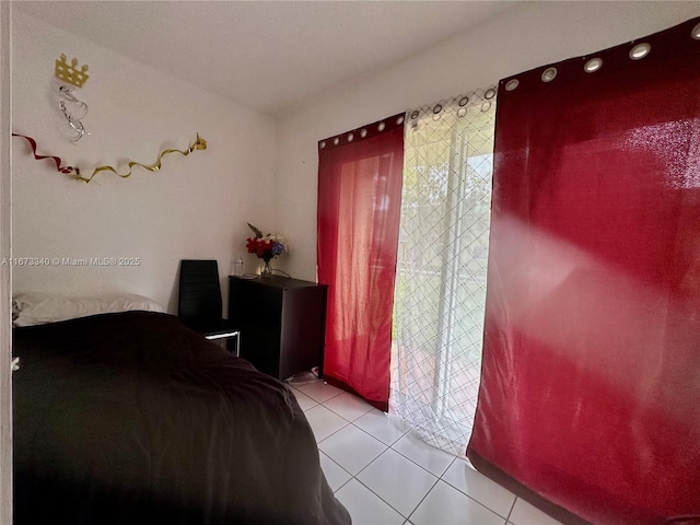 bedroom with light tile patterned floors