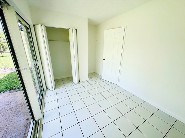 505 NW 177th St Unit 139, Miami Gardens, FL 33169 - unfurnished bedroom with a closet, light tile patterned floors, and baseboards