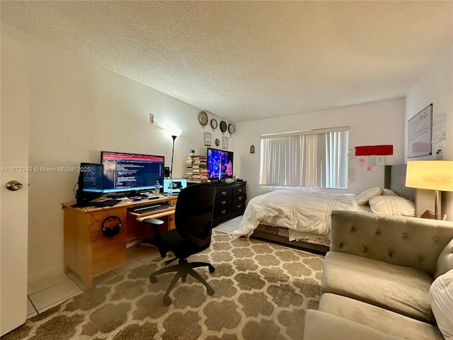 bedroom with tile patterned flooring, a textured wall, and a textured ceiling