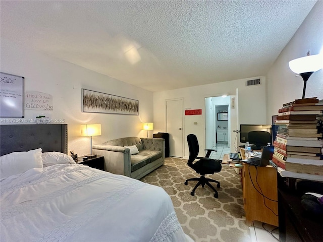 bedroom featuring visible vents and a textured ceiling