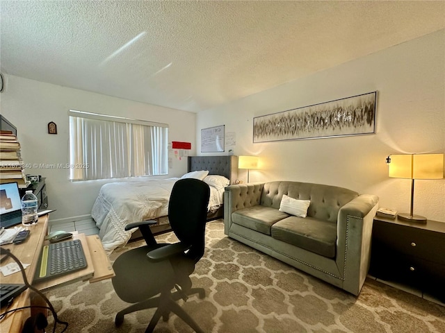 bedroom featuring a textured ceiling and carpet flooring