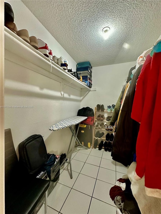 spacious closet featuring tile patterned flooring