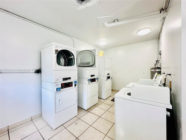 common laundry area with stacked washing maching and dryer, independent washer and dryer, water heater, and light tile patterned flooring