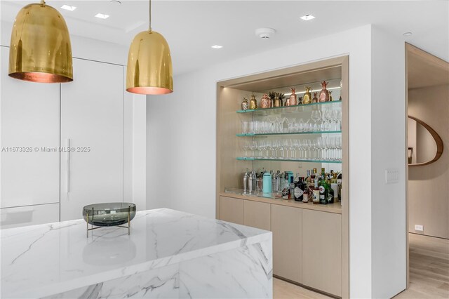 kitchen with white cabinets, sink, light hardwood / wood-style flooring, light stone countertops, and stainless steel appliances