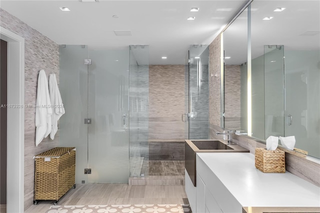 bathroom with vanity and a shower with shower door