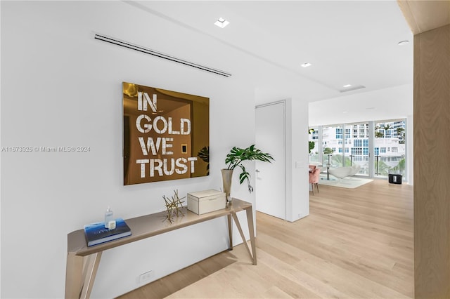 corridor featuring expansive windows and light hardwood / wood-style floors