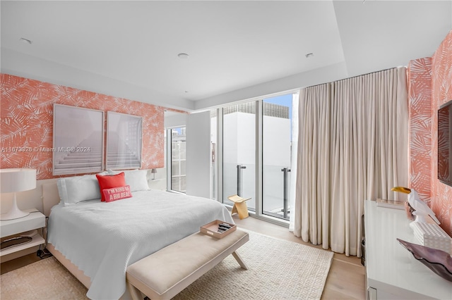 bedroom featuring access to outside and light hardwood / wood-style floors