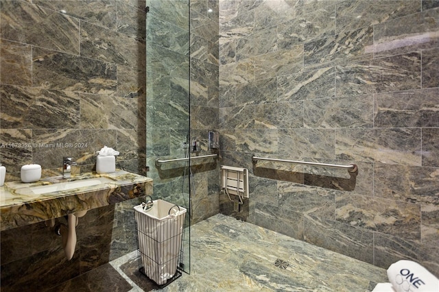 bathroom with sink and tile walls