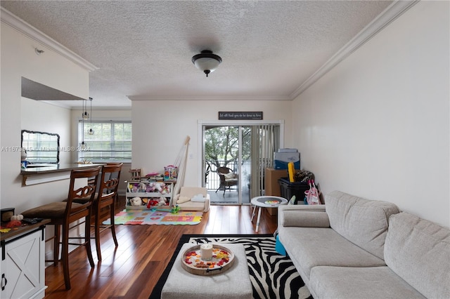 living room with wood-type flooring, crown molding, and a textured ceiling