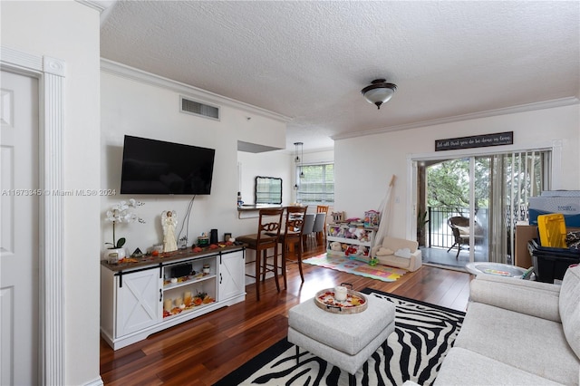 living room featuring a textured ceiling, dark wood-type flooring, and crown molding