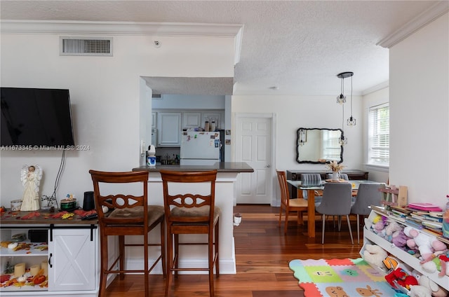 interior space with wood finished floors, visible vents, and a textured ceiling