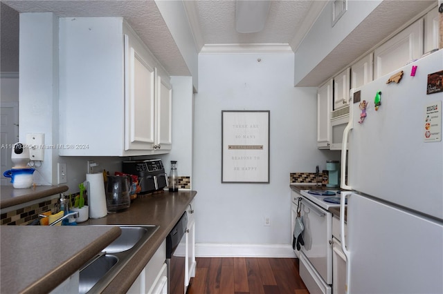 kitchen with a textured ceiling, dark wood-type flooring, white cabinets, white appliances, and ornamental molding