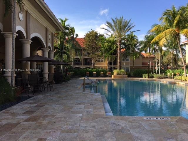 view of swimming pool featuring a patio area