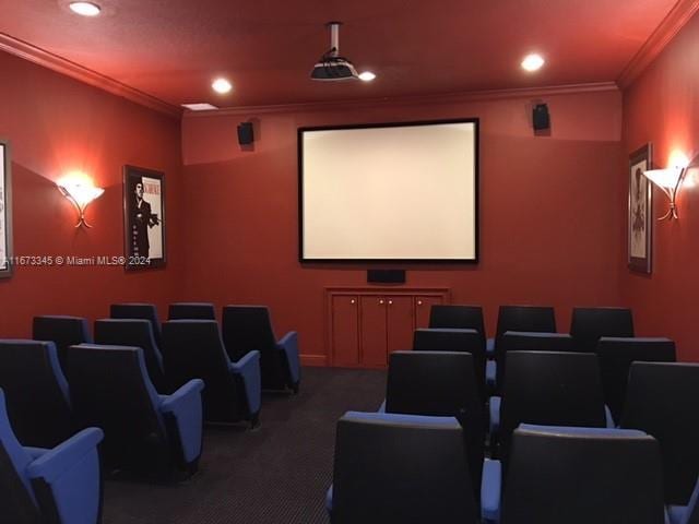 carpeted cinema with recessed lighting and crown molding
