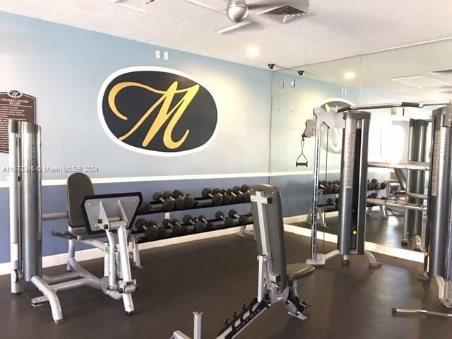 exercise room with a textured ceiling