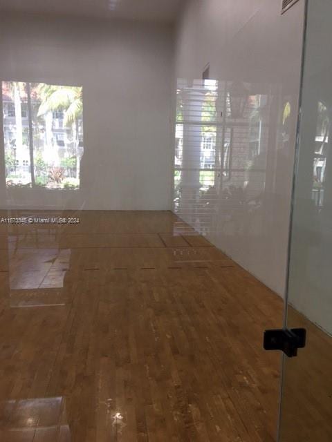 unfurnished room with wood finished floors