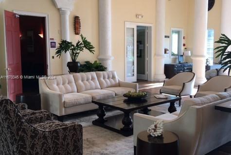 living area featuring ornate columns