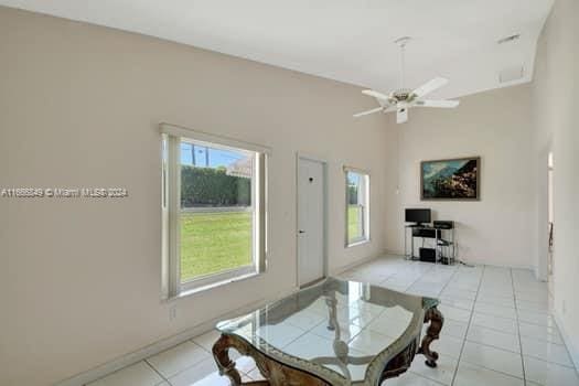 tiled dining area with ceiling fan