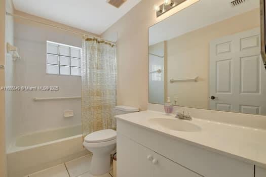 bathroom featuring visible vents, toilet, shower / washtub combination, vanity, and tile patterned flooring