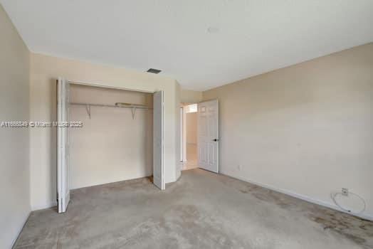 5127 Robino Cir, West Palm Beach, FL 33417 - unfurnished bedroom with carpet flooring and a closet