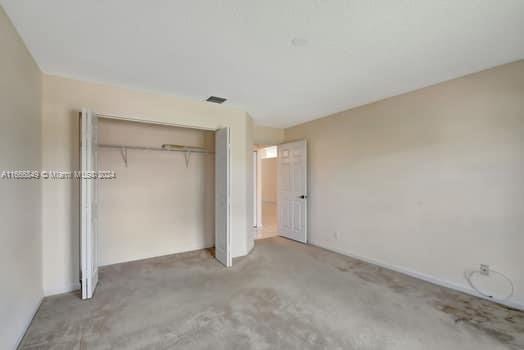 unfurnished bedroom with a closet