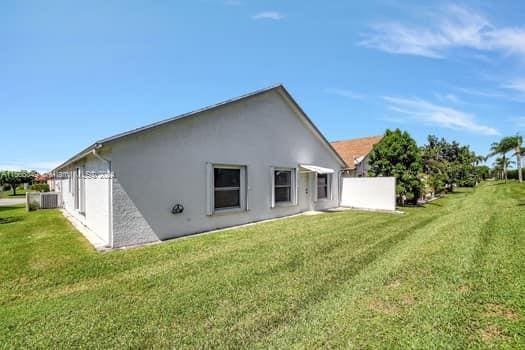 rear view of property with a lawn