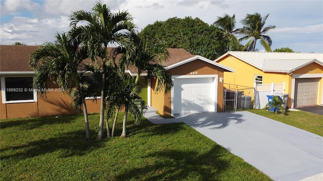 ranch-style home with a garage and a front lawn