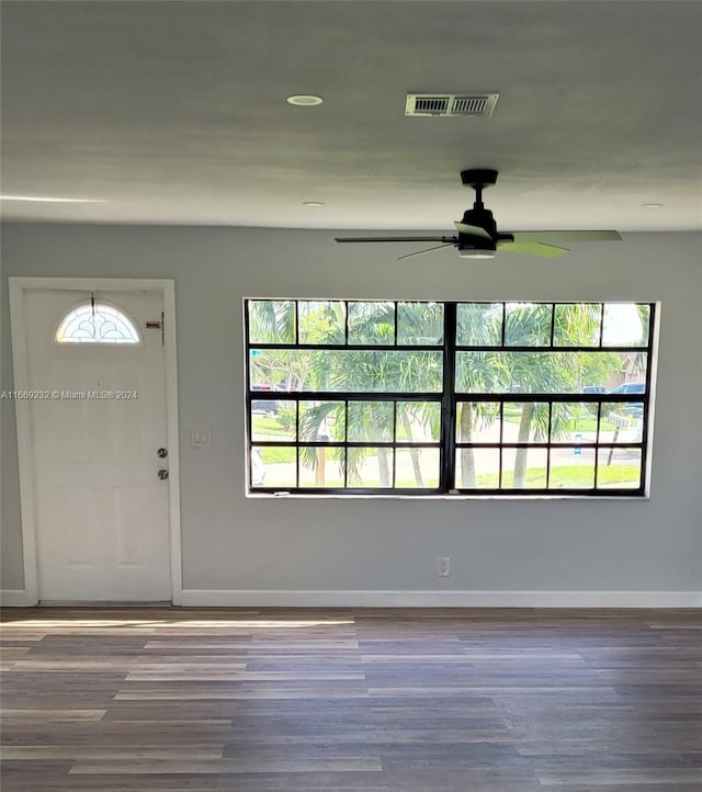 entryway featuring ceiling fan and dark wood-type flooring