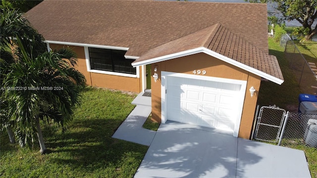 garage featuring a lawn