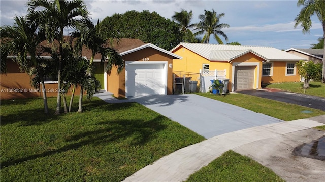 ranch-style home featuring a garage and a front lawn