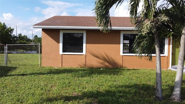 view of side of property with a yard