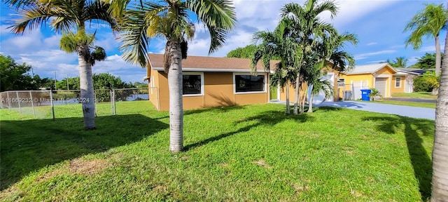 view of front of property featuring a garage and a front lawn