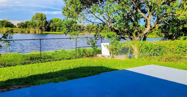 view of yard with a patio area and a water view