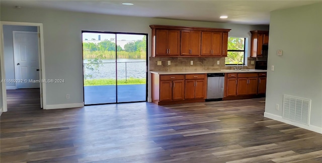 kitchen with dishwasher, a healthy amount of sunlight, dark hardwood / wood-style floors, and sink